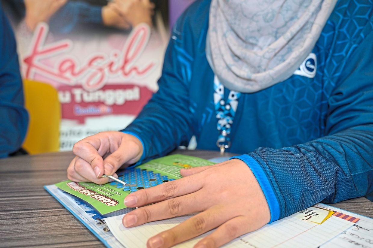 The Ringgit Diary challenges participants to save daily through the 'scratch and save game'.