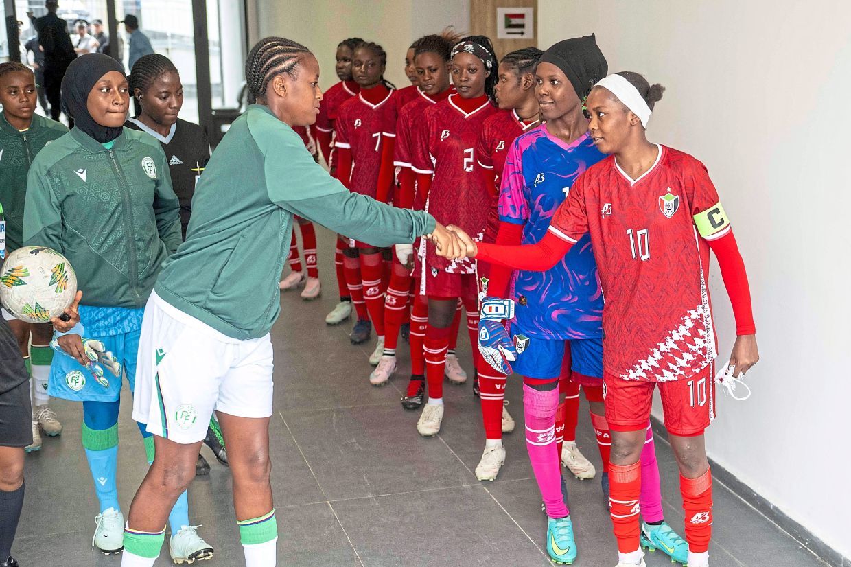 Sudan’s U-17 women’s national team (right) shakes hand with Comorros women’s national team, ahead of their match. Photo: AP
