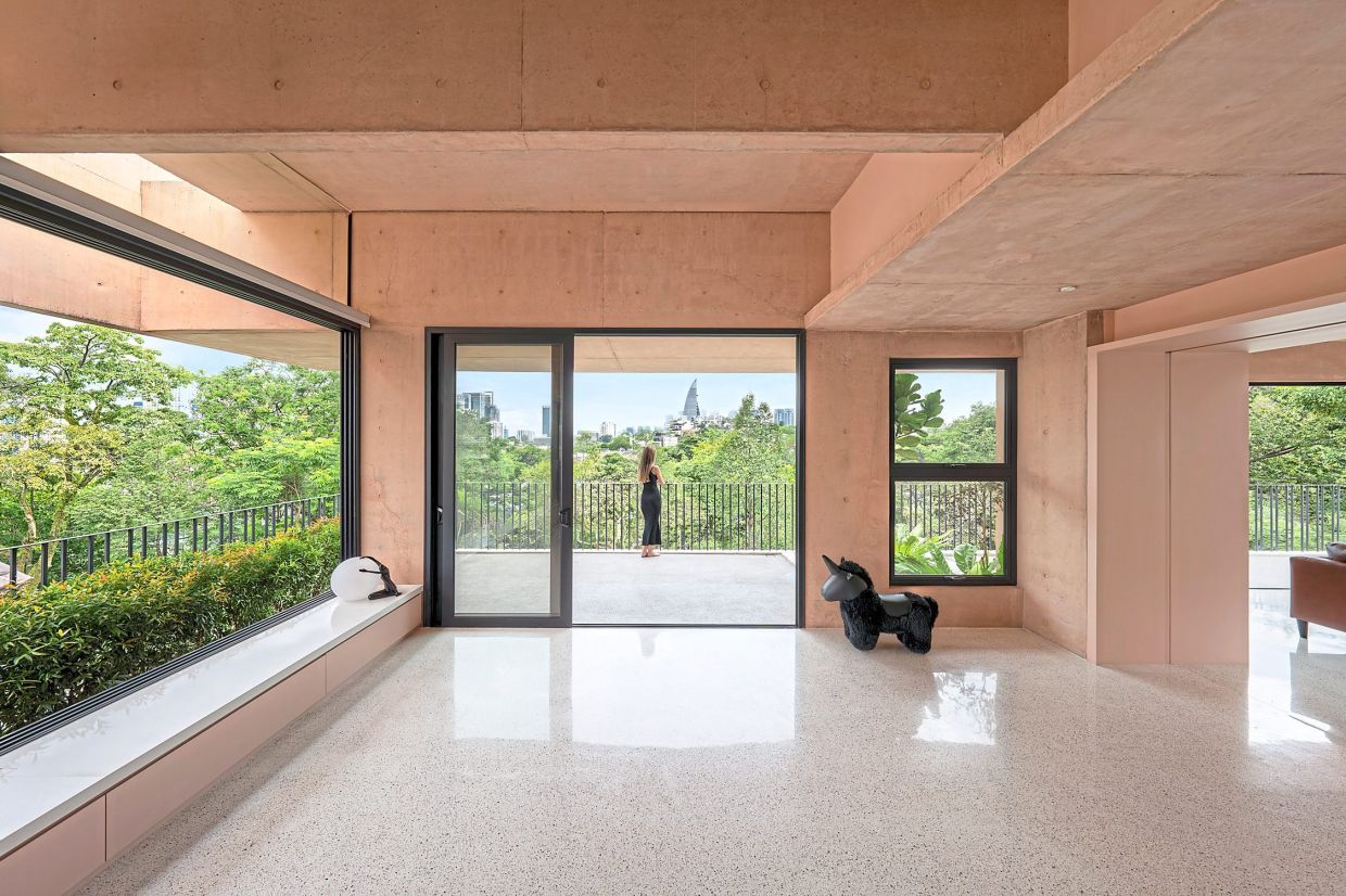 Nestled in greenery, the balcony of Armoua House offers an expansive view of the Kuala Lumpur city skyline. — Fabian Tan Architect