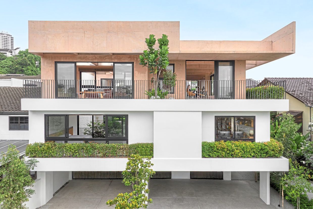 Moving away from the conventional grey of raw concrete, Armoua House is finished in a soft pink shade.