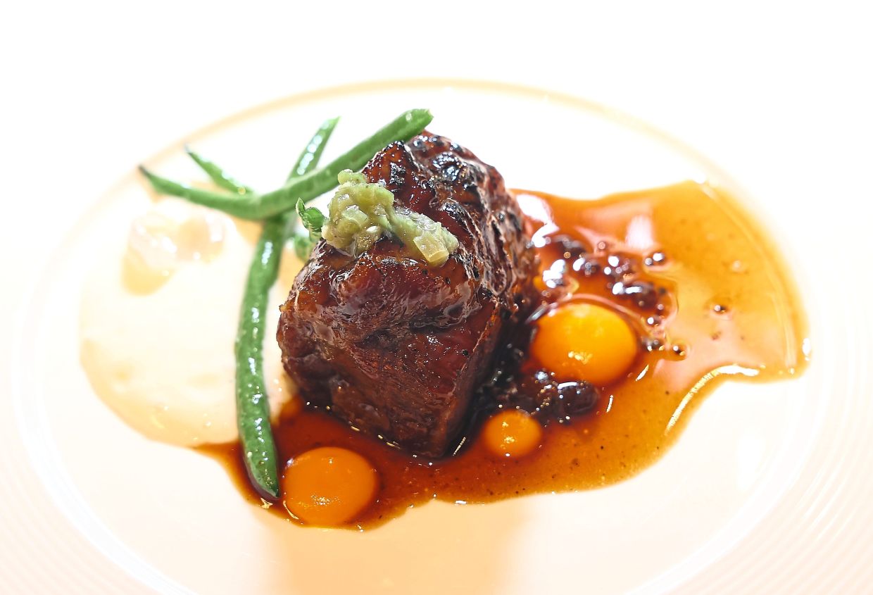Braised beef cheeks served with carrot puree, shallots and beef jus.