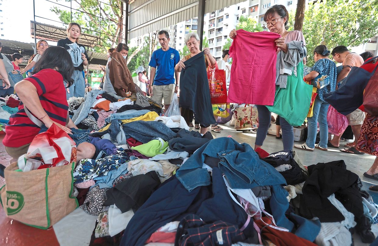 Visitors choosing pre-loved clothes at the Air Itam Free Market 6.0.