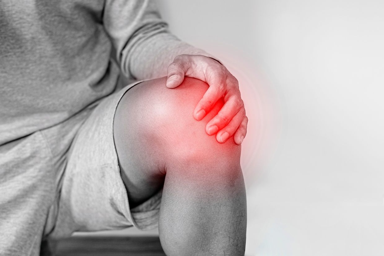 Knee strain is a common injury from pickleball and padel due to quick stops and repetitive jumping on hard flooring. — Dreamstime