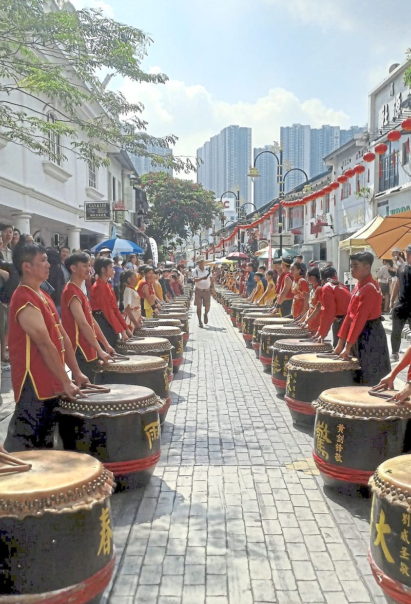 A hundred drummers lining up along Tan Hiok Nee Heritage Street in Johor Baru for a rare, large-scale outdoor performance. 