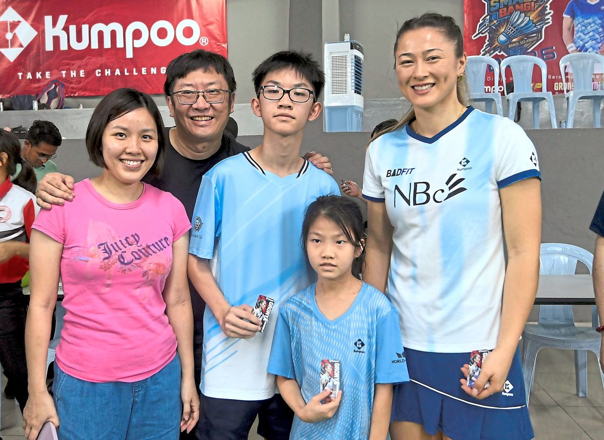 A treat for participants is the appearance by Somerville, seen with the Ong family (above) and signing a T-shirt during the meet-and-greet alongside Low (below).