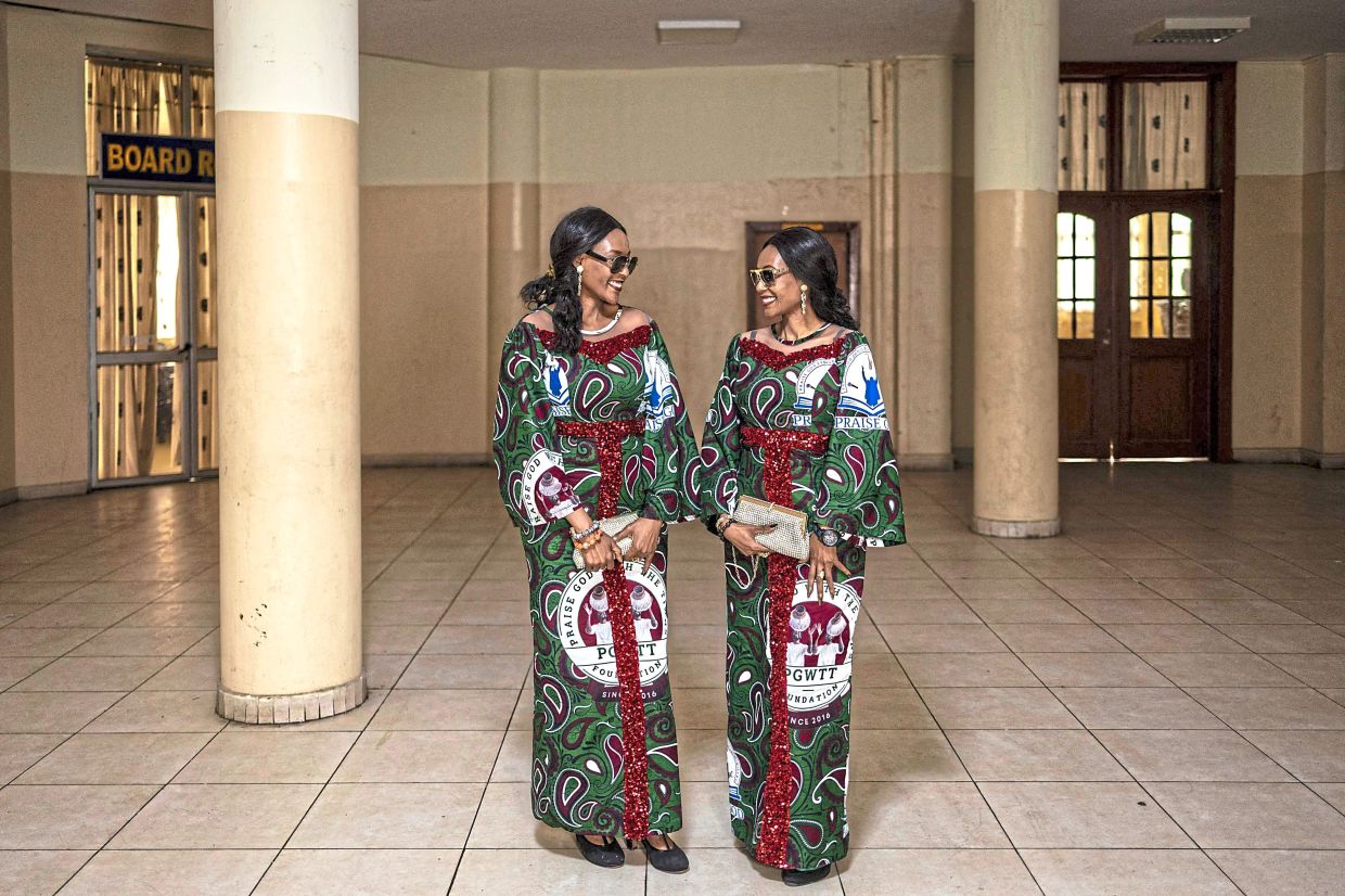 Twin sisters Taiwo (left) and Kehinde Tee-Kay Campbell at the wedding reception of their twin friends.