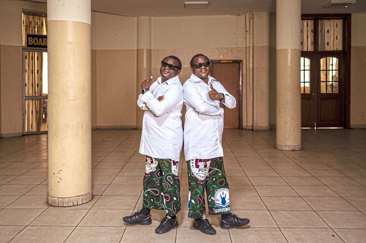 Twin brothers Taiwo (left) and Kehinde Oshigbo at the wedding in Ibadan, a region in southwestern Nigeria famous for its high number of twin births.