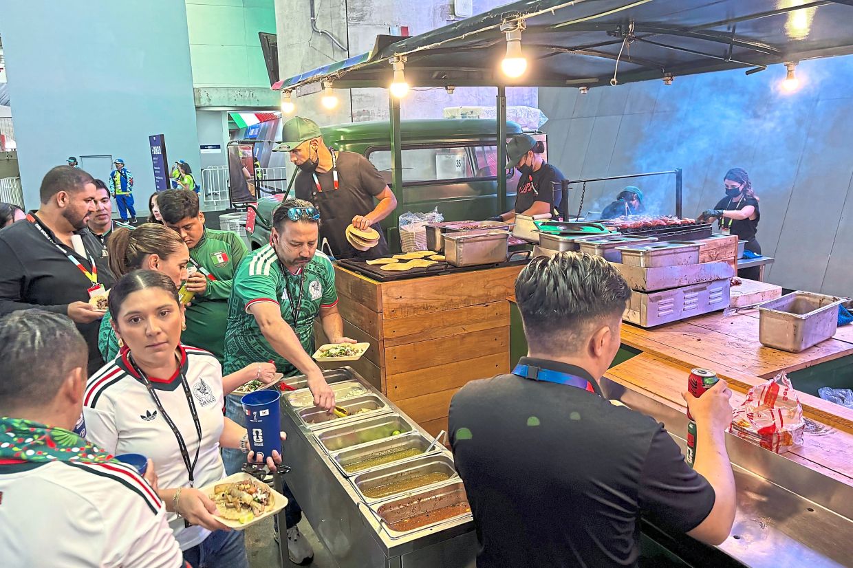 Football fans during the first match between Mexico and South Korea buying food at a concession stand inside Guadalajara Stadium in Mexico.