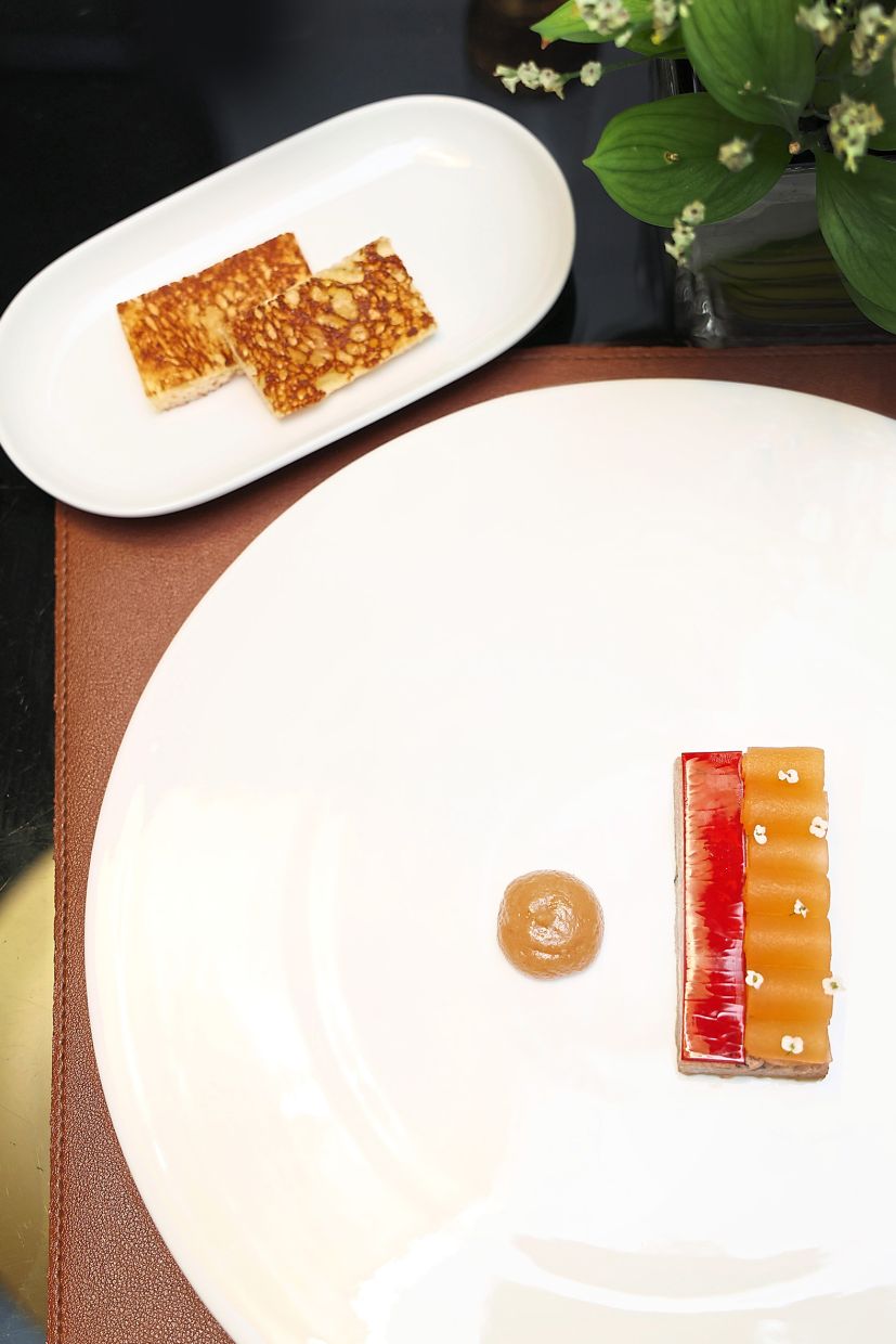 Above: Foie Gras Terrine with compressed strips of melon, fig chutney and bite-sized crispy toast.Left: Royale Custard features sliced Boston lobster tail in a velvety crustacean emulsion.