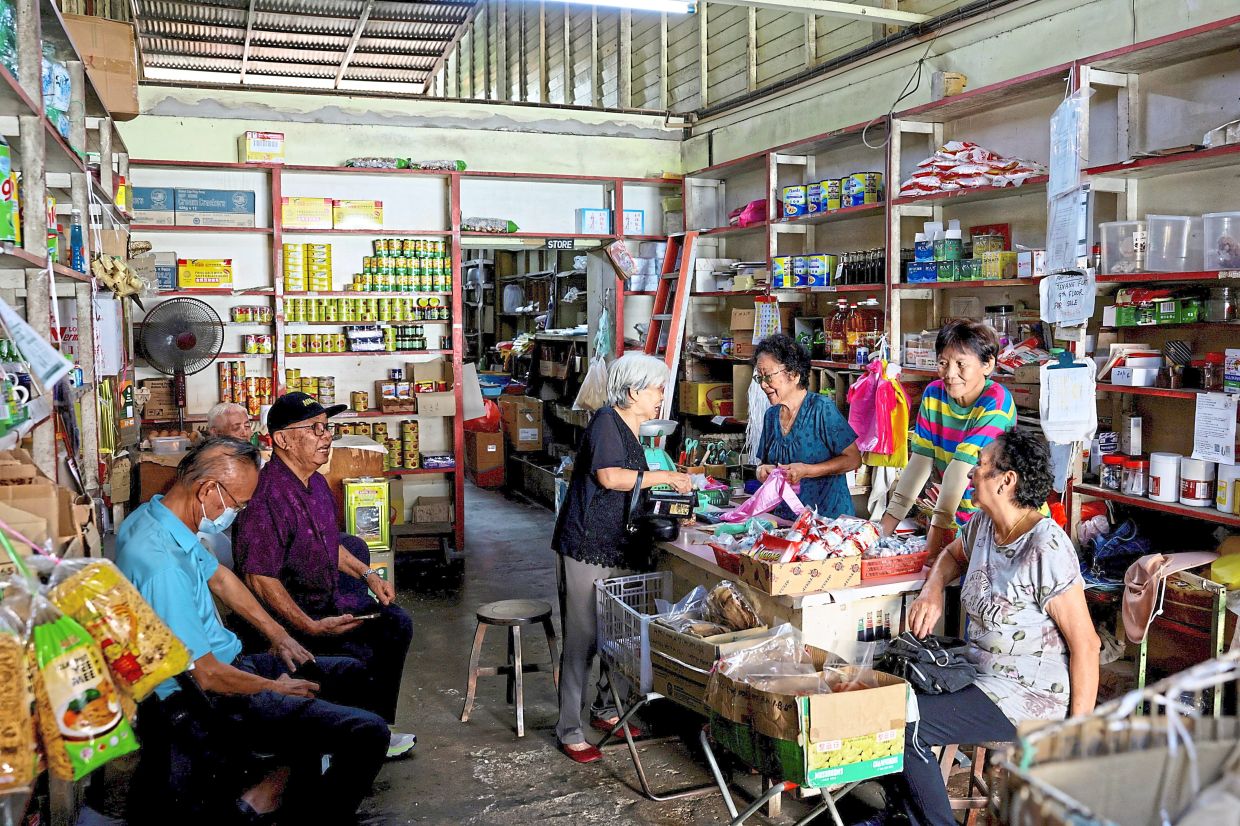 The convenience store owned by Ma (behind counter, second from right) becomes a lively spot when her friends gather.