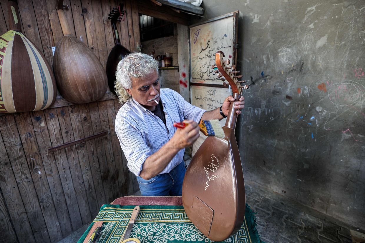 Suhail Abu Shawish hopes one day to manufacture high-quality Palestinian instruments that can compete internationally and showcase Gaza's craftsmanship to the world. Photo: AFP 
