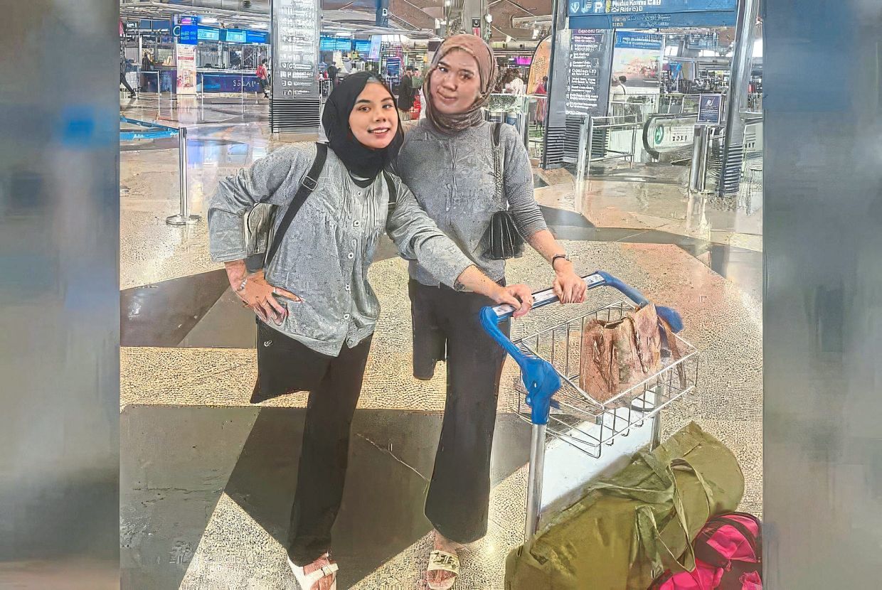 Resilient sisters: Nik Haziera (left) with her sister Nik Haznita. Both sisters have come to terms with losing their legs after an accident last year. — Photo from Sinar Harian