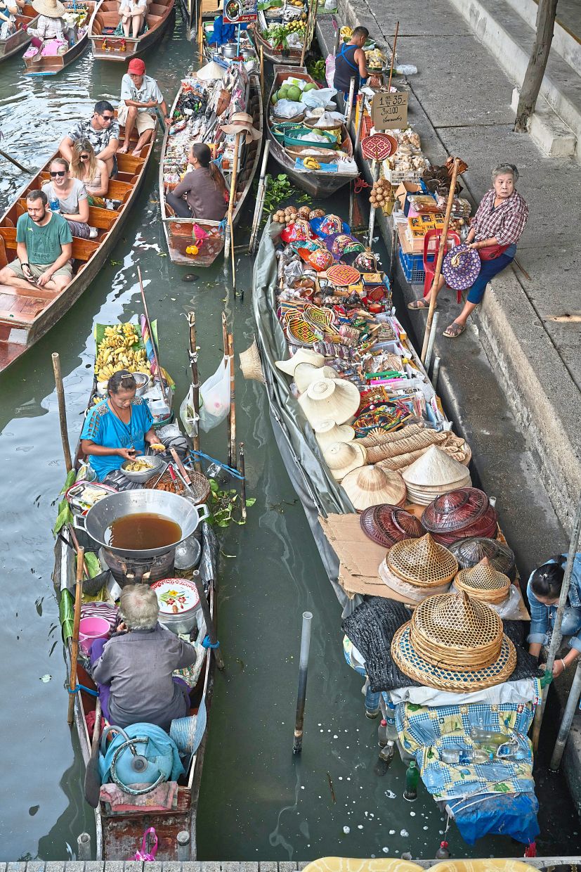 Visit Damnoen Saduak Floating Market for a glimpse into Thailand’s rich trading culture. — Unsplash