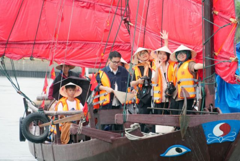 Visitors enjoying the inaugural journey aboard a traditional thuyen ba vach, a distinctive sailing boat once used by Quang Ninh's coastal fishing communities. - Vietnam News/ANN