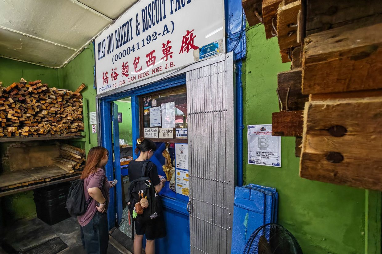 Customers queue to purchase freshly baked bread at Hiap Joo Bakery.