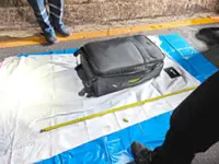 Aussie man charged over dead teen in suitcase