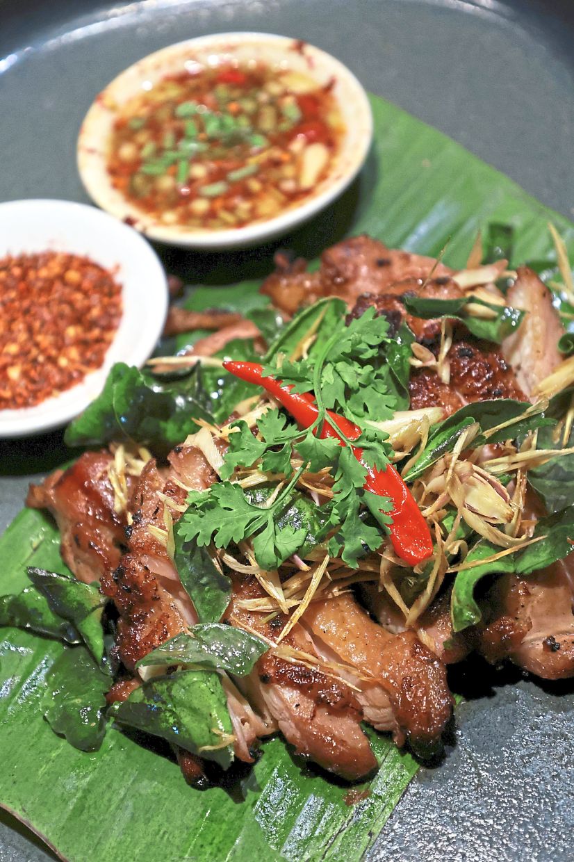The grilled Gai Yang or marinated chicken with smoky charred notes and paired with the spicy and tangy Naam Jim Jaew dipping sauce.