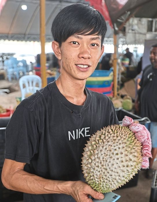 Hua Mian with durians from his family’s orchard.