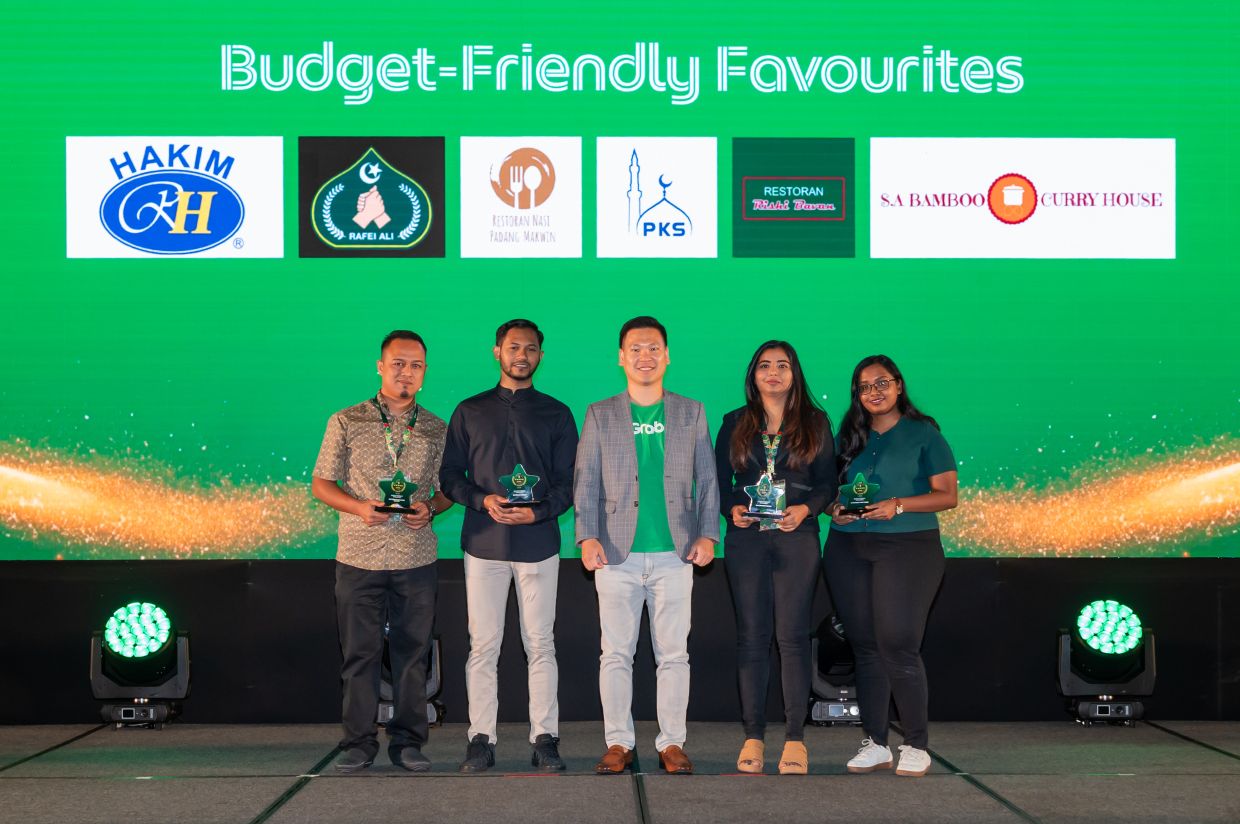 Winners of the Budget-Friendly Favourites category commemorate their win on stage alongside a representative from Grab.