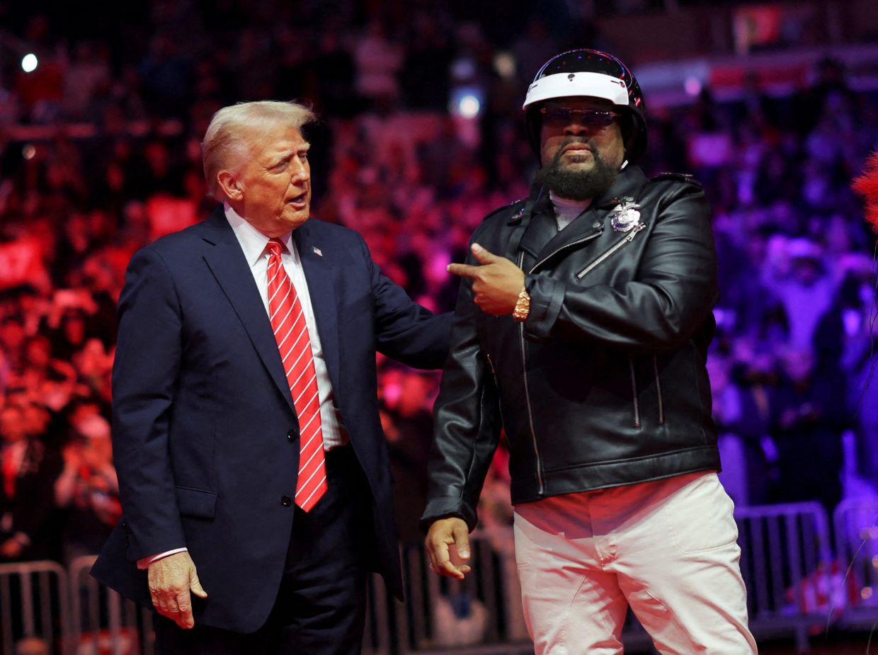 President Donald Trump stands next to Victor Willis, member of the Village People, before he is scheduled to be inaugurated for a second term, in Washington on Jan 19, 2025. Photo: Reuters