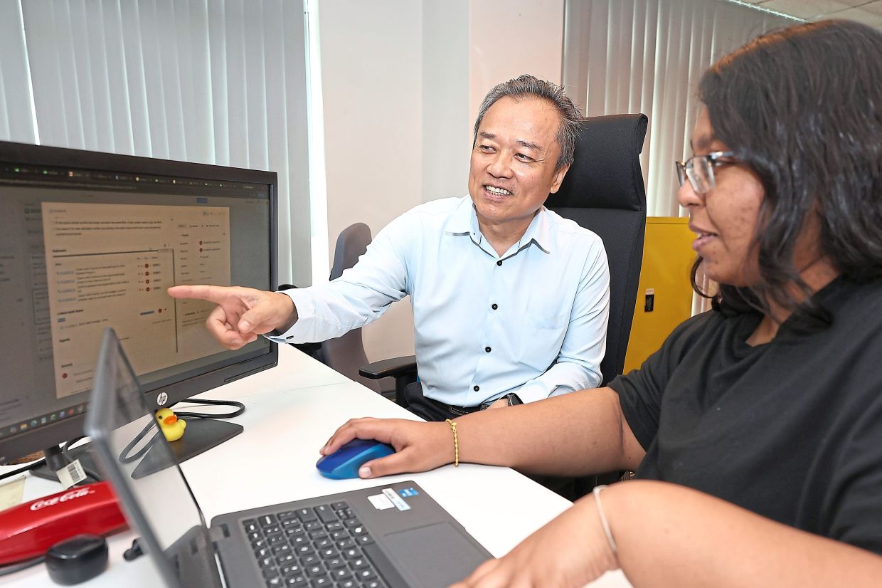 Sia discussing a project with his colleague, Sangeetha Loganathan, as part of SMG’s collaborative work culture. Photos: The Star/Yap Chee Hong