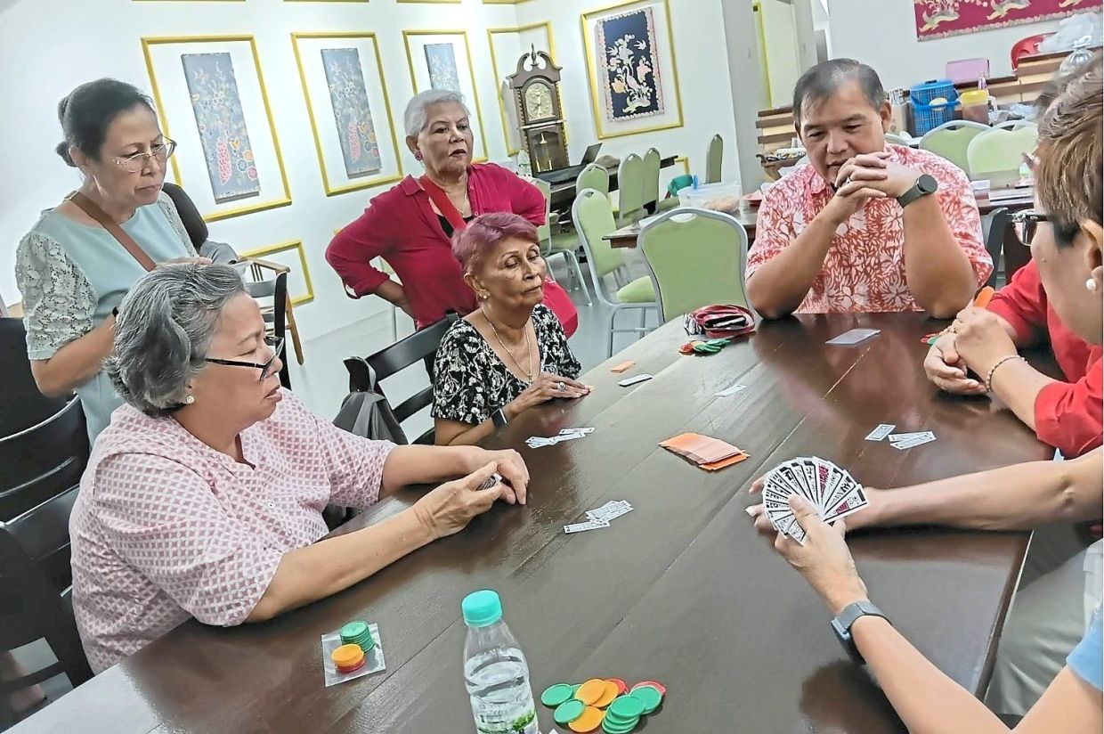 Tan (seated, third from right) is leading efforts to revive Cherki through workshops, competitions and community activities. Photo: Hairul Asraf Abu Hussain
