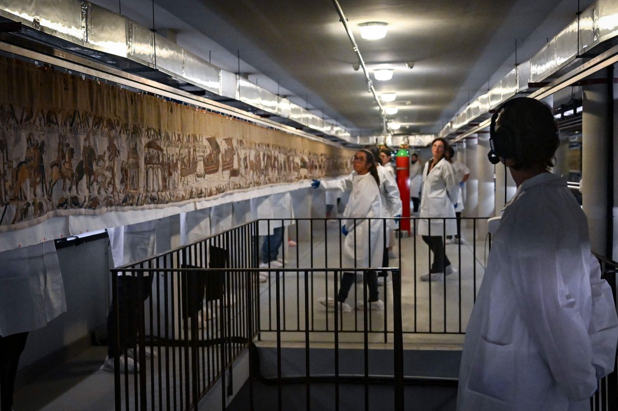 A special glass container, which the British Museum believes is the world's longest showcase, has been made to display and protect the tapestry. Photo: AFP