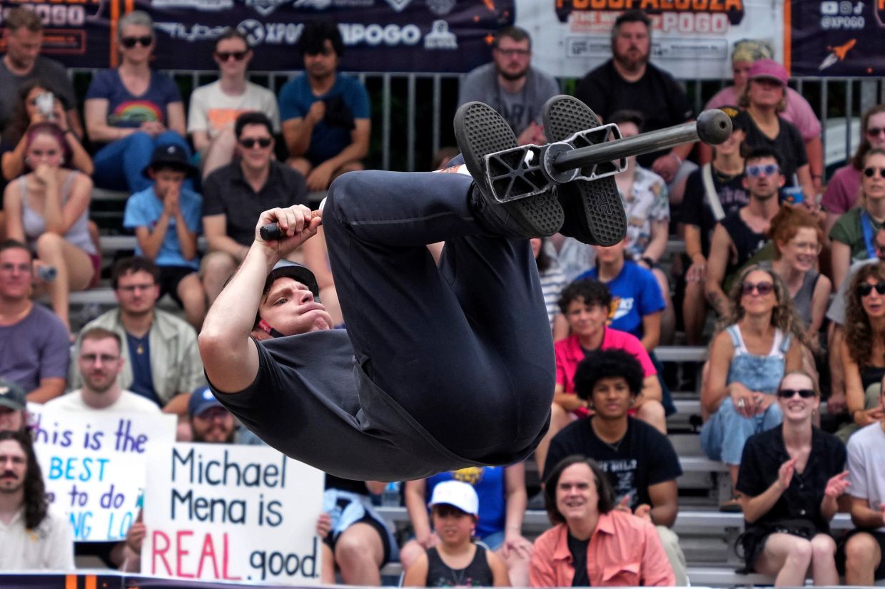 Extreme pogo athlete Michael Mena does a back flip during his first place effort during the Big Air competition at Pogopalooza.