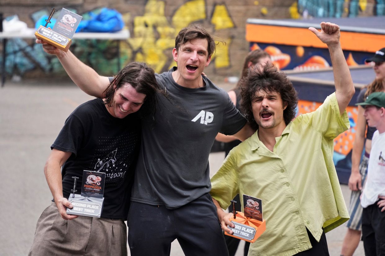 Extreme pogo athlete Michael Mena (centre) celebrates his first place win in the Best Trick competition with Henry Cabelus, left, second place, and Dalton Smith, third place at Pogopalooza 2026.
