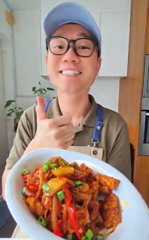 Thye and his creation, crispy sambal tofu and tempeh, stir fried in red palm oil.