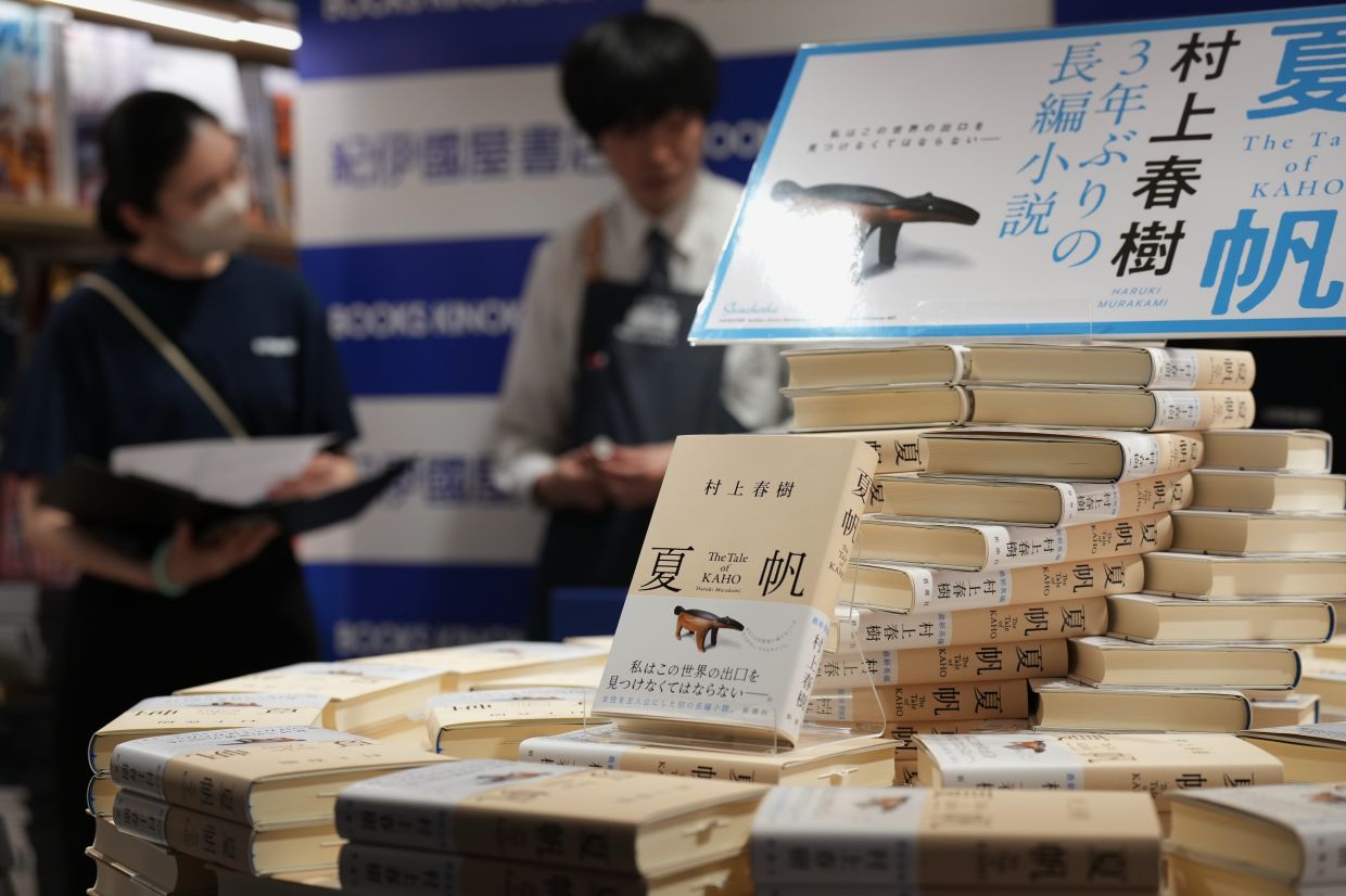 Bookstore staff prepare a countdown event for their customers to receive copies they pre-purchased, of author Haruki Murakami's new book.