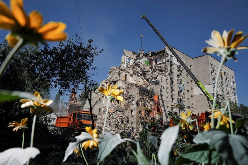 Ukrainian rescuers clear rubble as Kyiv mourns 30 killed in Russian attack