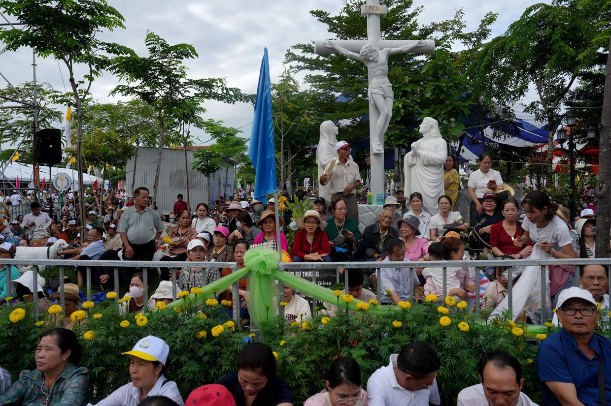 People attend the beatification mass for the late Vietnamese Catholic priest Francis Xavier Truong Buu Diep at the Tac Say Pilgrimage Center in Ca Mau province in southern Vietnam. Tens of thousands of Catholics flocked to a small parish in the Mekong Delta on July 2 for the first beatification ceremony held on Vietnamese soil, with an envoy of Pope Leo XIV presiding over the special mass. -- Photo by AFP