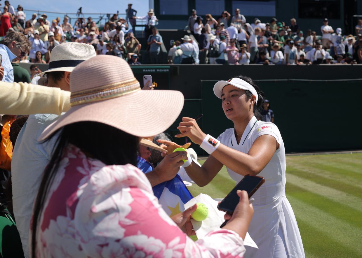 Philippines' Alexandra Eala signs autographs for fans after winning her second-round match against Australia's Maya in the Wimbledon Championships at the All England Lawn Tennis and Croquet Club, London. Photo: REUTERS/Marko Djurica