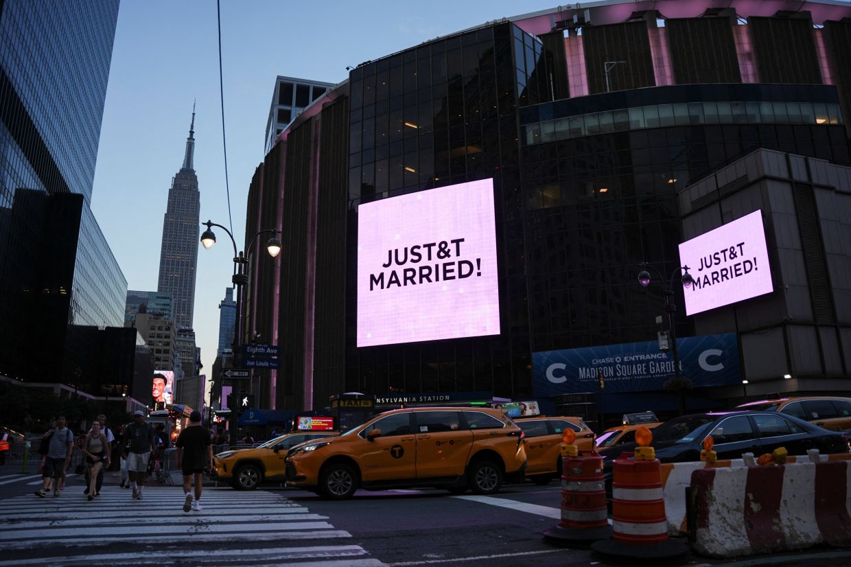 A screen displays a message referencing singer Taylor Swift and Travis Kelce outside Madison Square Garden, the venue for their wedding celebrations. Photo: Reuters