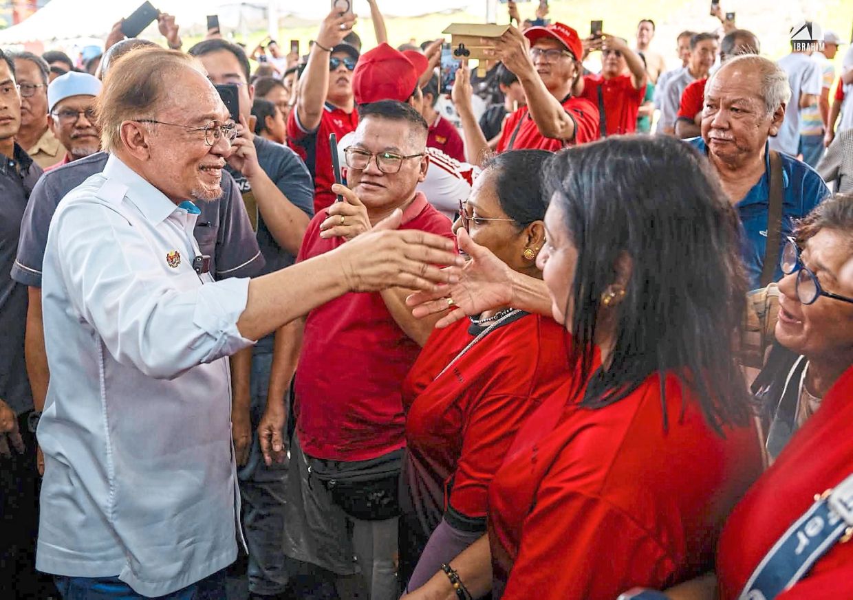 Reaching out: Anwar interacting with supporters at the Kita GenK Madani X Anak Muda Bukit Batu event in Kulai, Johor.