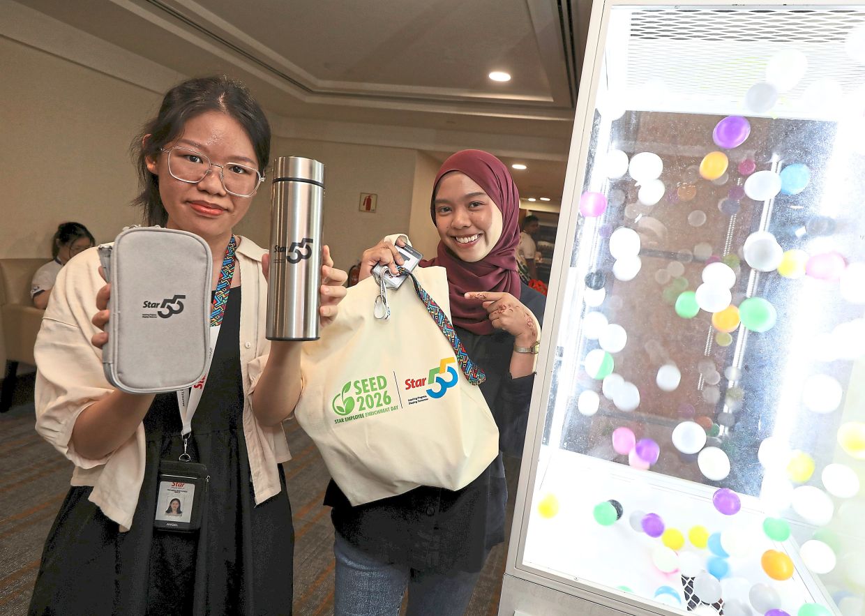 Tung (left) and Nur Irwani with the company’s limited-edition 55th anniversary merchandise.