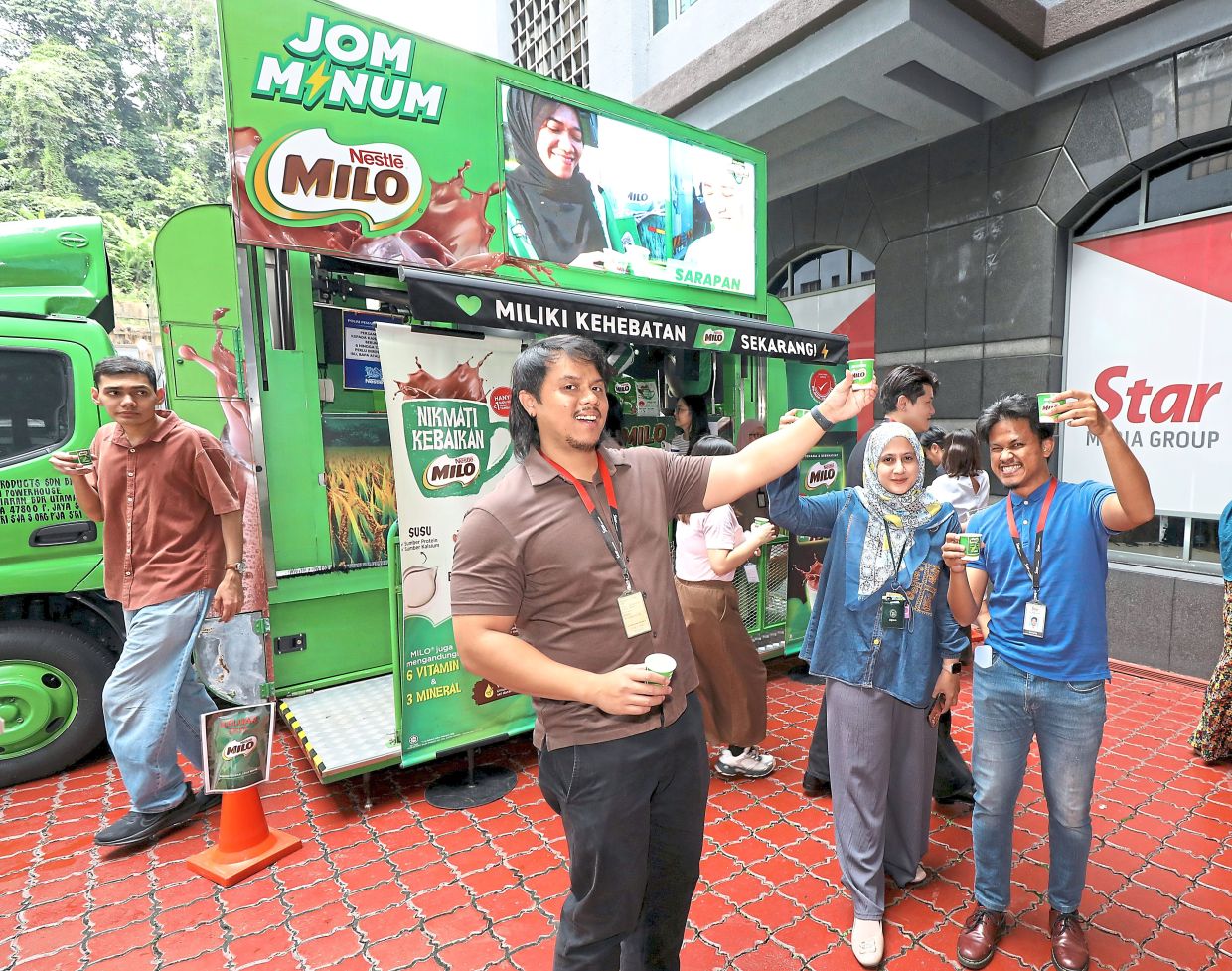 SMG staff enjoying cold Milo from the truck in tribute to childhood memories.