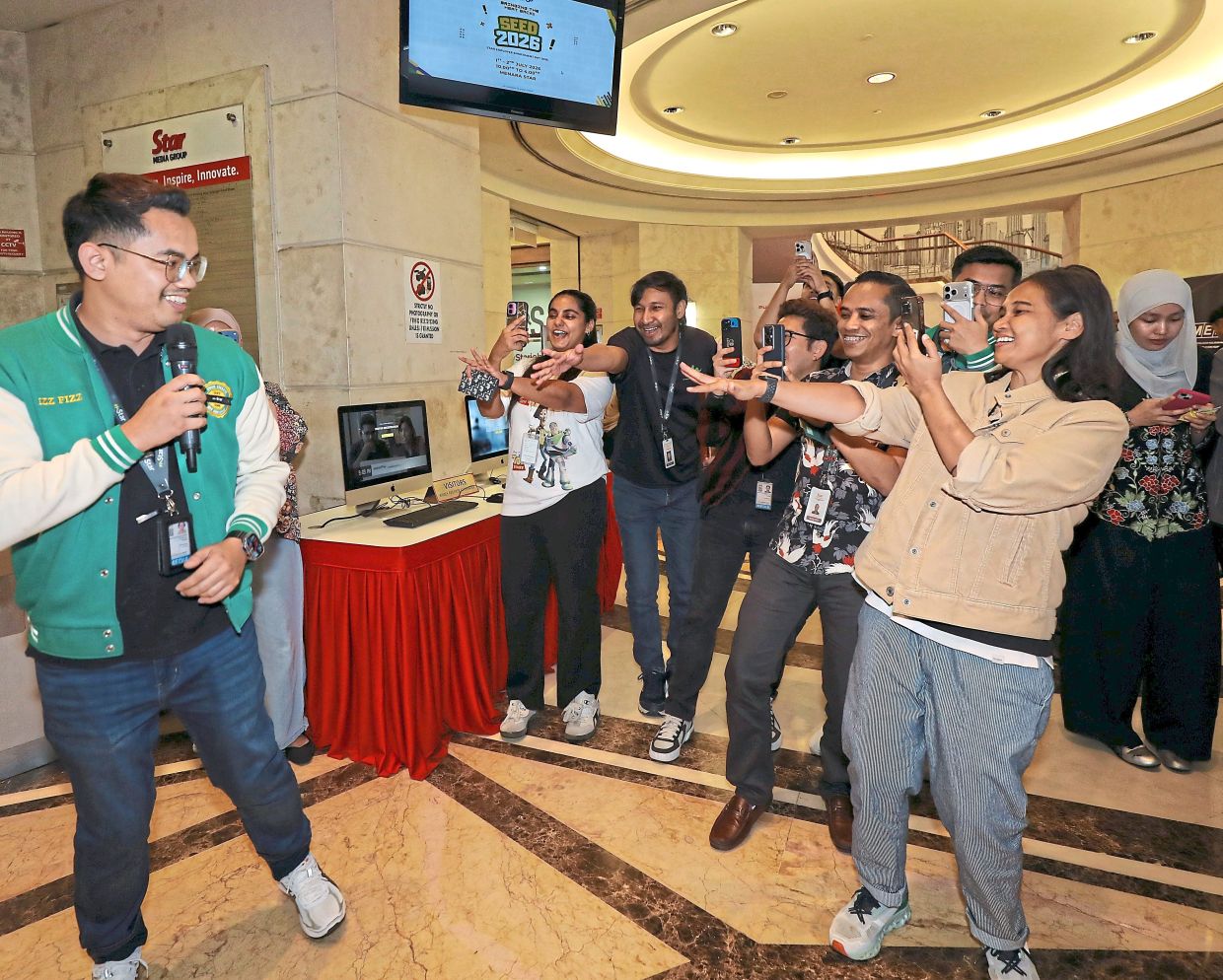Journalist Mohd Faiz Izzat Shaihidi (left) entertaining the crowd at SEED 2026.