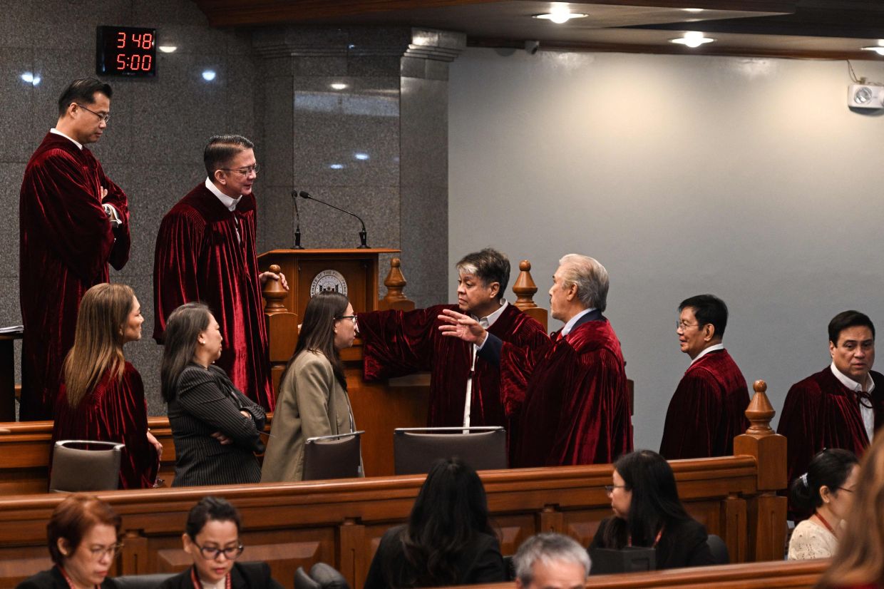 Philippine senators, acting judges of the impeachment court, speak with each other as they have a break during the impeachment trial of Philippine Vice President Sara Duterte at the Senate of the Philippines in Pasay, Metro Manila on Tuesday, July 7, 2026.-- Photo by NOEL CELIS / POOL / AFP
