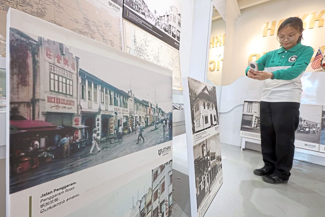 A young visitor admiring an exhibition on Batu Pahat’s heritage buildings.