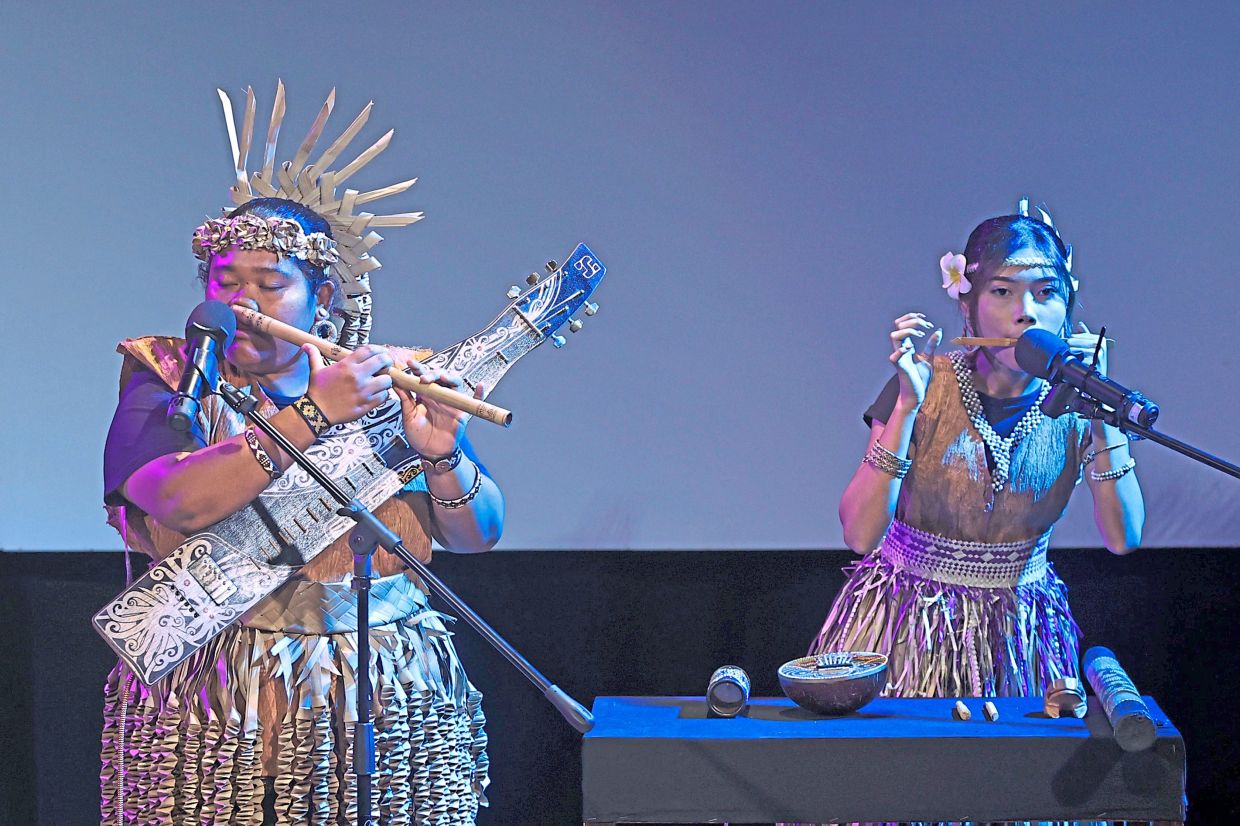 During the poetry and musical performance, Ndang (left) and her sister Suriza performed with a range of traditional instruments. Photo: The Star/Azman Ghani