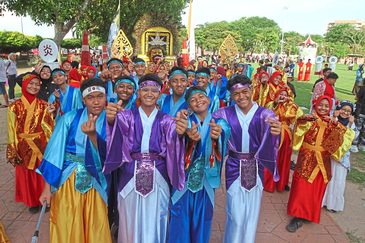 A team posing for photos after performing their dance.