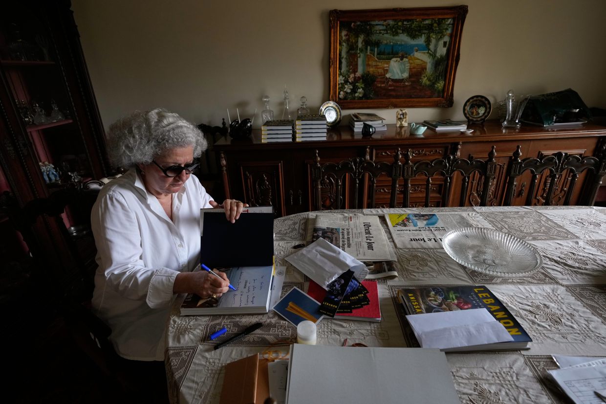 Anissa Helou, 74, one of the Middle East's most acclaimed cooks and food writers, signs a copy of her new book.