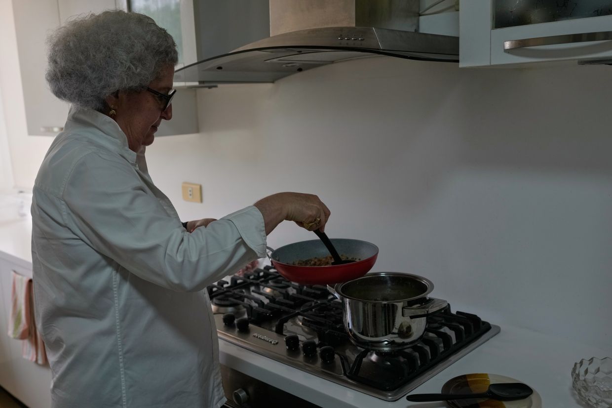 Anissa Helou, 74, one of the Middle East's most acclaimed cooks and food writers, prepares awarma, a traditional Lebanese lamb confit, at her late mother's apartment.