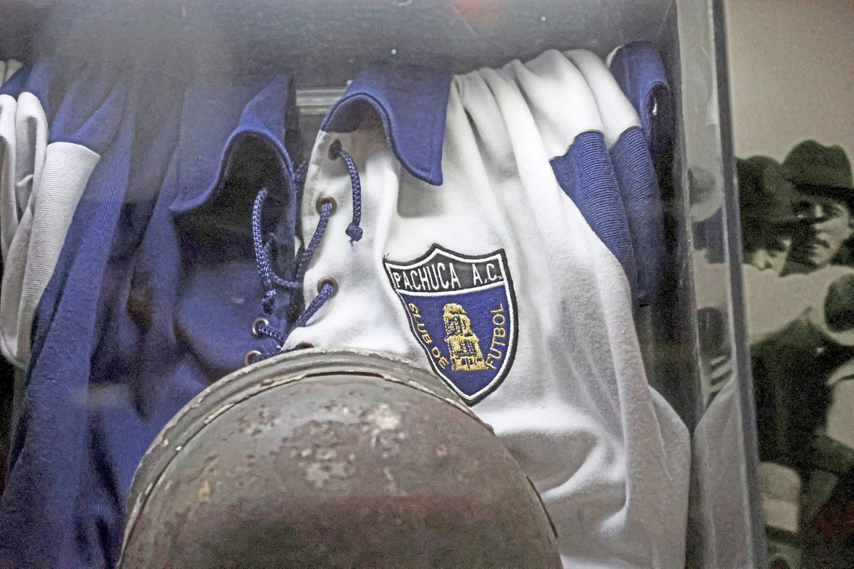 An F.C. Pachuca jersey and a mining helmet are on display at the Museo del Futbol in Pachuca, home to Mexico's oldest football club. — Reuters