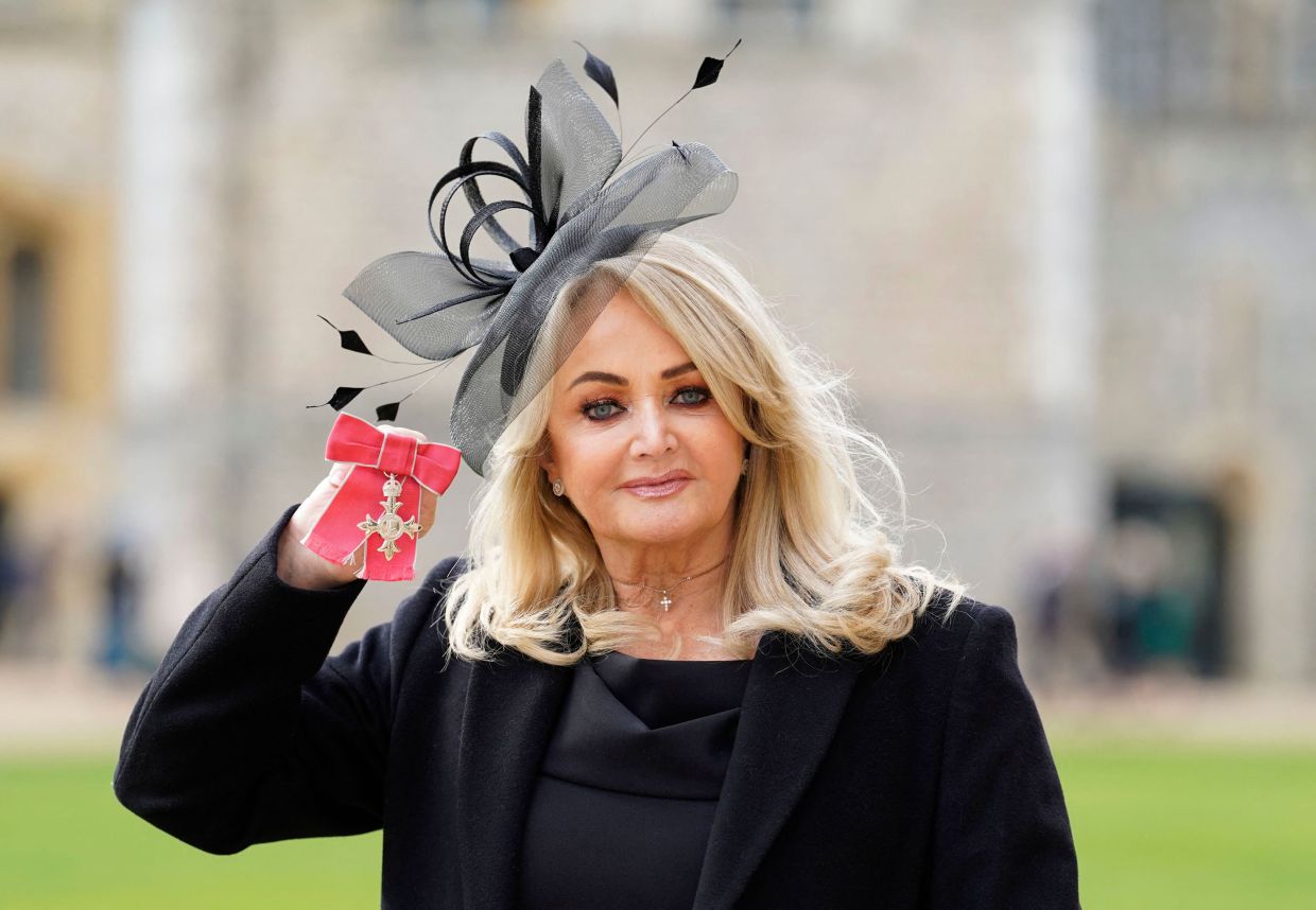 Bonnie Tyler poses with her medal after being appointed a Member of the Order of the British Empire (MBE) during an investiture ceremony at Windsor Castle in Windsor, west of London, on Feb 1, 2023. Photo: AFP
