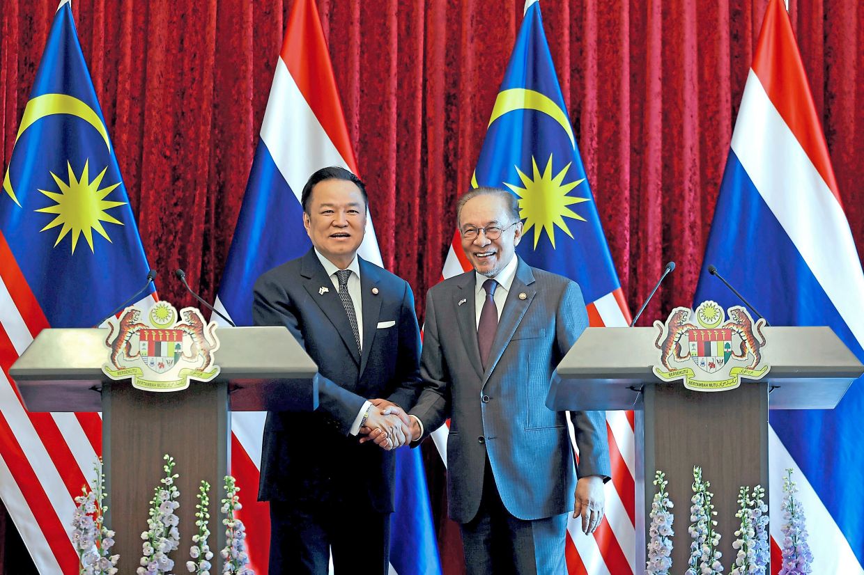 Firm commitment: Anwar and Anutin posing for a photograph before delivering a joint statement at Perdana Putra Building today. — Bernama
