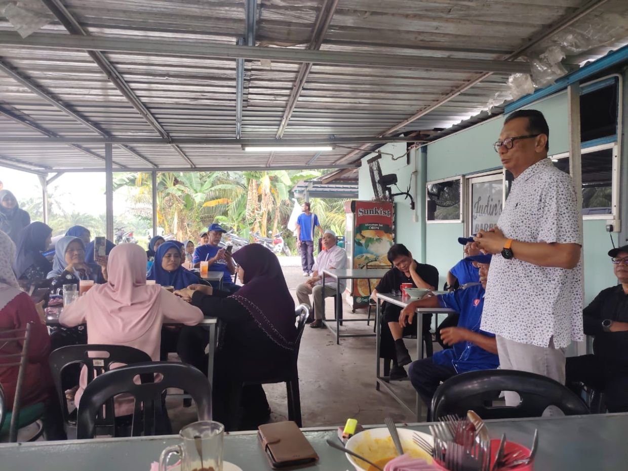 Barisan Candidate Datuk Samsolbari Jamali addressing voters at a stall in his rural area of Semarang here.