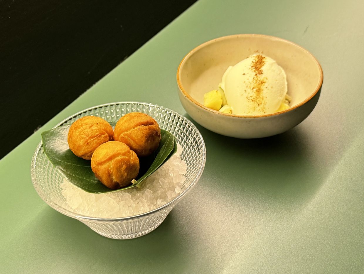 The dessert fuses the uniquely Malay cekodok with the idea of Chinese/Peranakan pineapple tarts alongside an Indian-style cucumber raita ice cream. — Photo: MICHAEL CHEANG/The Star